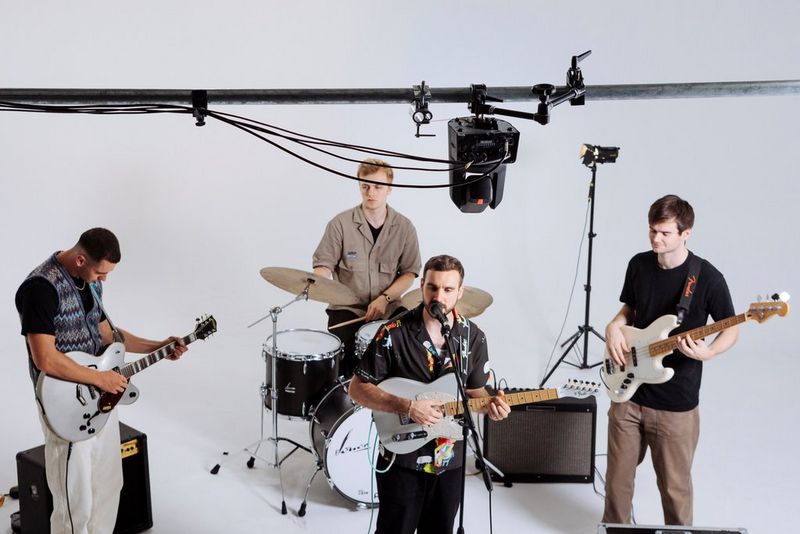 A Canon CR-N700 PTZ camera filming a vocalist, guitarists and a drummer in a band. 