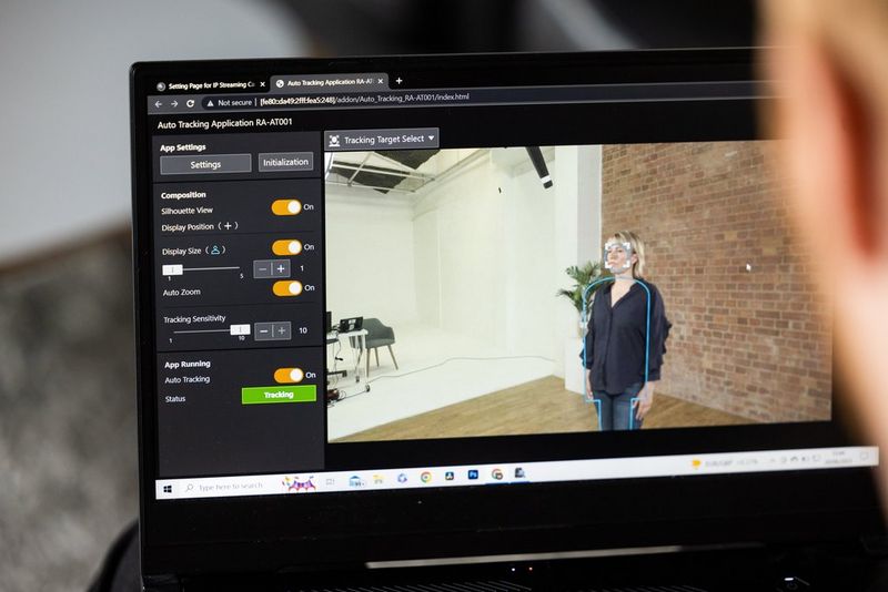 A laptop screen shows the Auto Tracking app's Tracking Target Select tool being used on a woman.