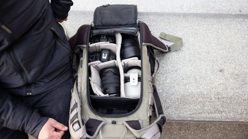 Action photographer Lorenz Holder's camera backpack, which is open to show Canon EOS R5 Mark II cameras and three Canon RF lenses.