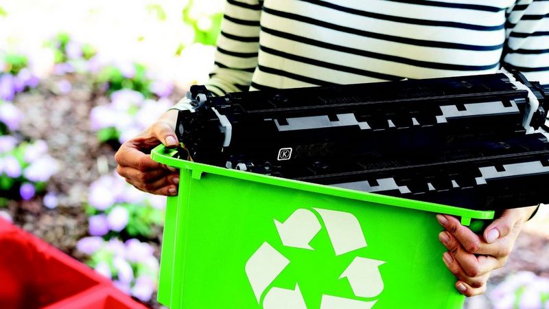 A cartridge that protrudes from a small container held by a person