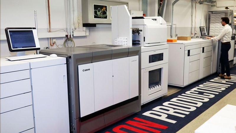Man standing at a large production printing machine