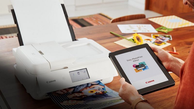 A person printing on a Canon PIXMA printer from a tablet using the Canon Easy-PhotoPrint Editor App.