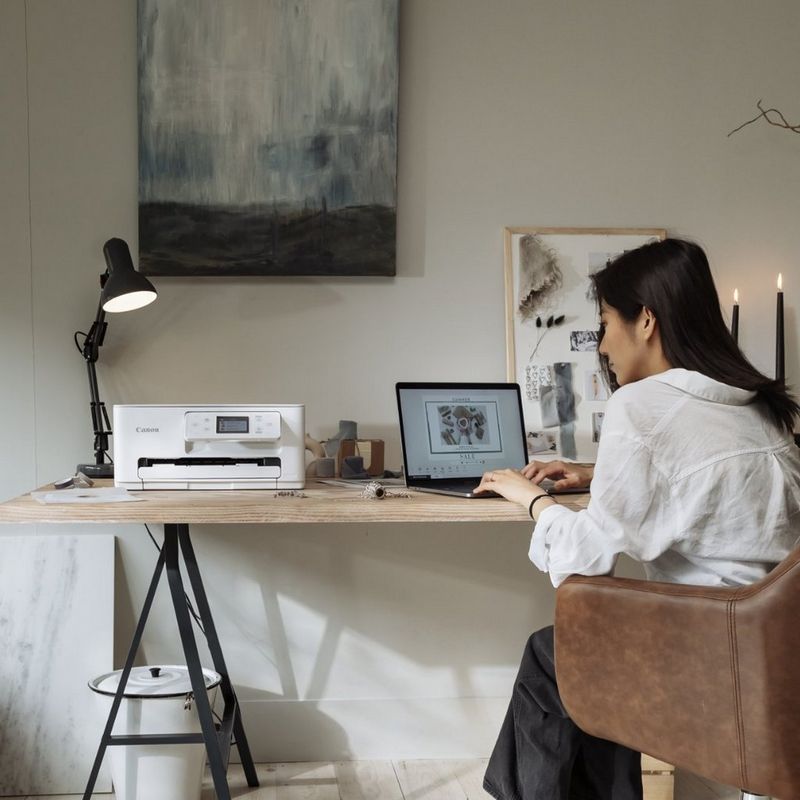 Woman sitting at a desk printing