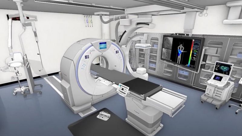 A computer generated 3D recreation of a scanning room with a CT scanner in the middle. In the room there are also medical machines.