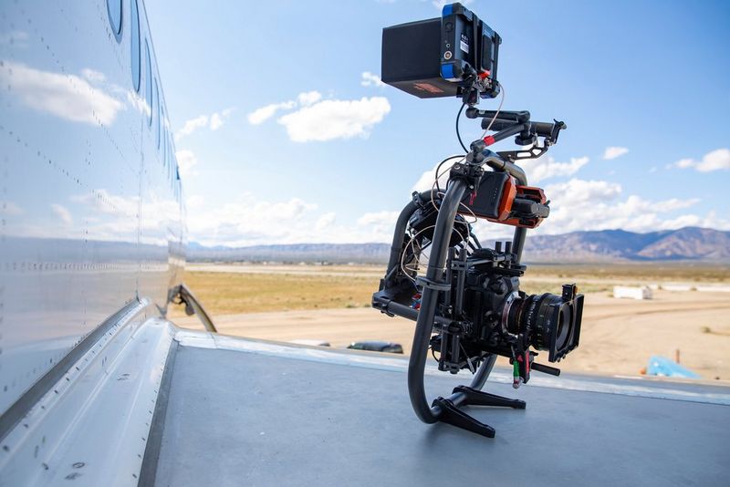  A Canon EOS C300 Mark III on a gimbal, resting on the wing of an aircraft. 