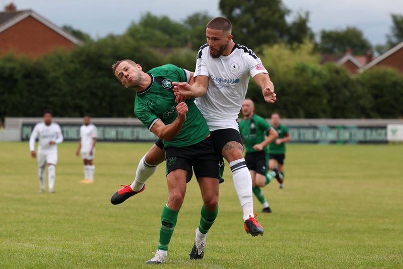 In a photo taken on a Canon EOS R3 by Molly Darlington, two football players clash into each other during a match.