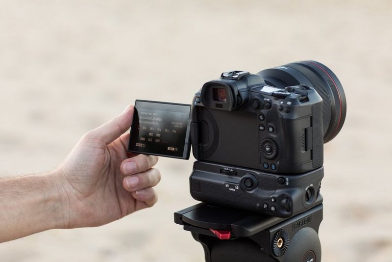 A photographer adjusts his camera to capture social media content. 