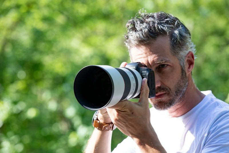 Filmmaker Martin Bissig holding the Canon EOS R5 fitted with an RF lens.