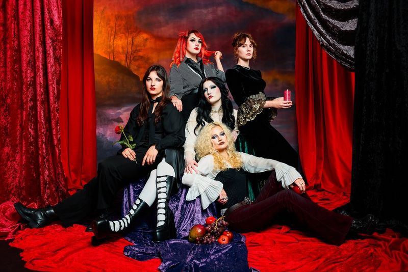  The five members of British rock band Venus Grrrls photographed on a Canon EOS R6 Mark III in an elaborate rich red velvet studio setting.