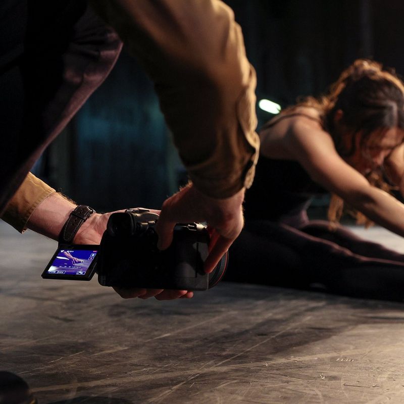 Canon EOS R6 held at a low angle shooting a dancer sitting on the floor
