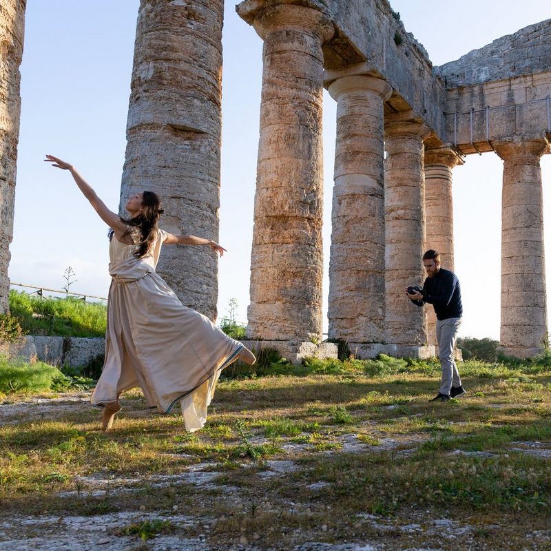 Shooting a ballet dancer in an open natural area surrounded with pillars