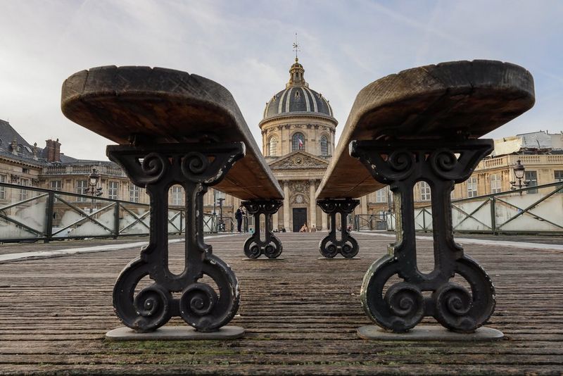 A building in Paris taken from a low angle, with benches in the foreground, taken on the Canon EOS R8 by Martin Bissig.