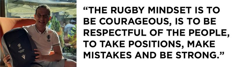 Left: a photograph of Eric Gauzins, sitting on an orange chair in front of a window on a sunny day. He is smiling and wearing and official’s rugby shirt with ‘World Rugby Referee’ embroidered on the front right. He holds a grey and black bag with a logo on the front. On the right, a quote that reads, “The rugby mindset is to be courageous, is to be respectful of the people, to take positions, make mistakes and be strong.”
