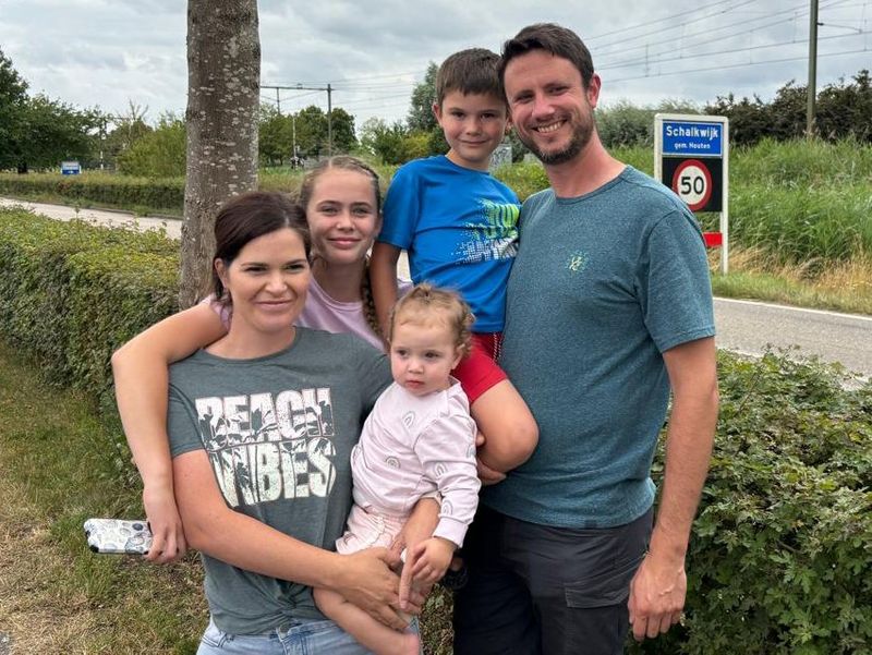 Geraldine Van Schalkwyk, her husband and three children pose for the camera by a roadside.