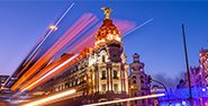 Light trails suspended in motion by a bus on a busy street in Madrid, Spain.