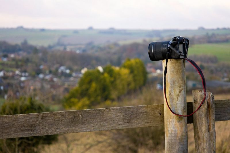 A Canon EOS RP perched on a fence post.