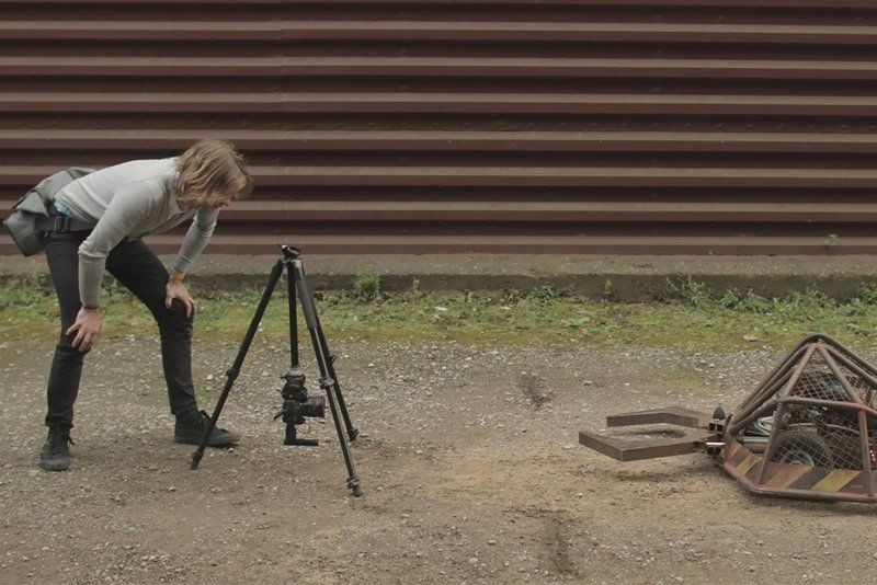 Geoff leaning over EOS 80D on a tripod filming a robot.