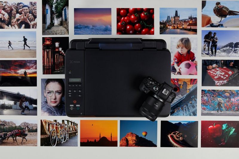 Canon PIXMA G640 с камерой на верхней панели, вокруг которой расположены печатные версии фотографий.