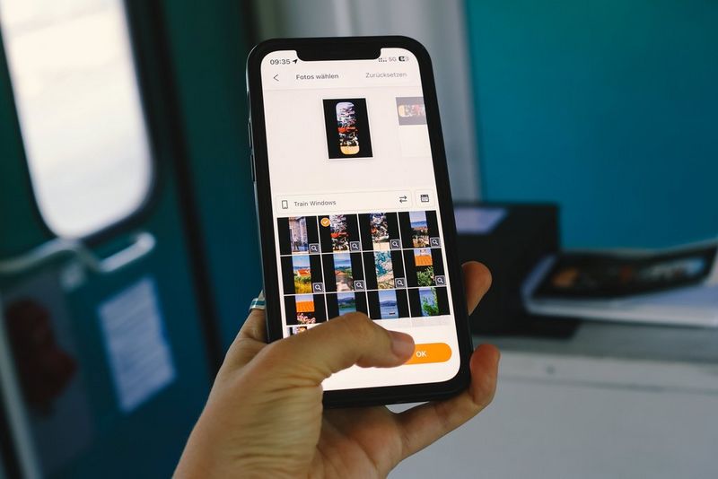  A user holding a smartphone with the Canon SELPHY Photo Layout app on the screen. A Canon SELPHY portable photo printer is visible in the background and a train door beyond.