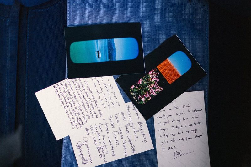 Some postcard-size photo prints produced on a Canon SELPHY CP1500 printer, some picture side up and some upside down with handwritten comments visible.