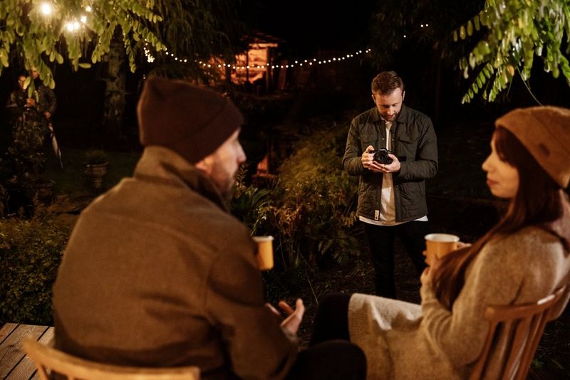 Par razgovara dok sjede s toplim napicima u ruci, a snima ih osoba koja drži EOS R6 Mark II tvrtke Canon.