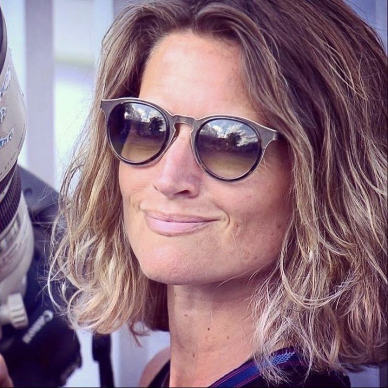 Close-up of a person wearing sunglasses, smiling