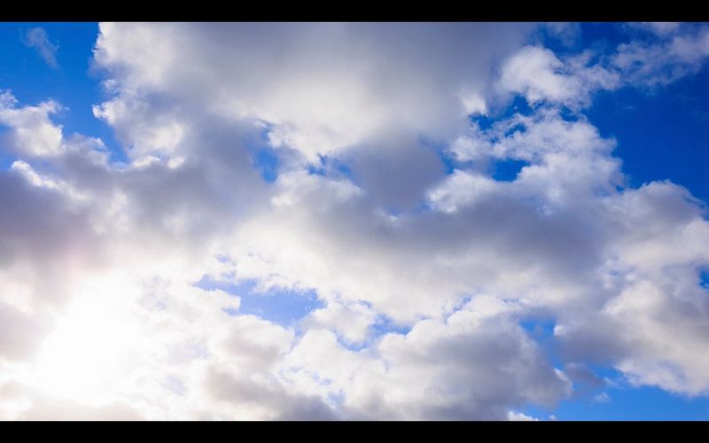 Jasně modrá obloha plná bílých mraků.