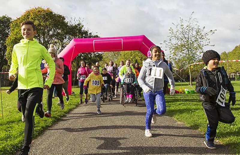 children running through finish line of race