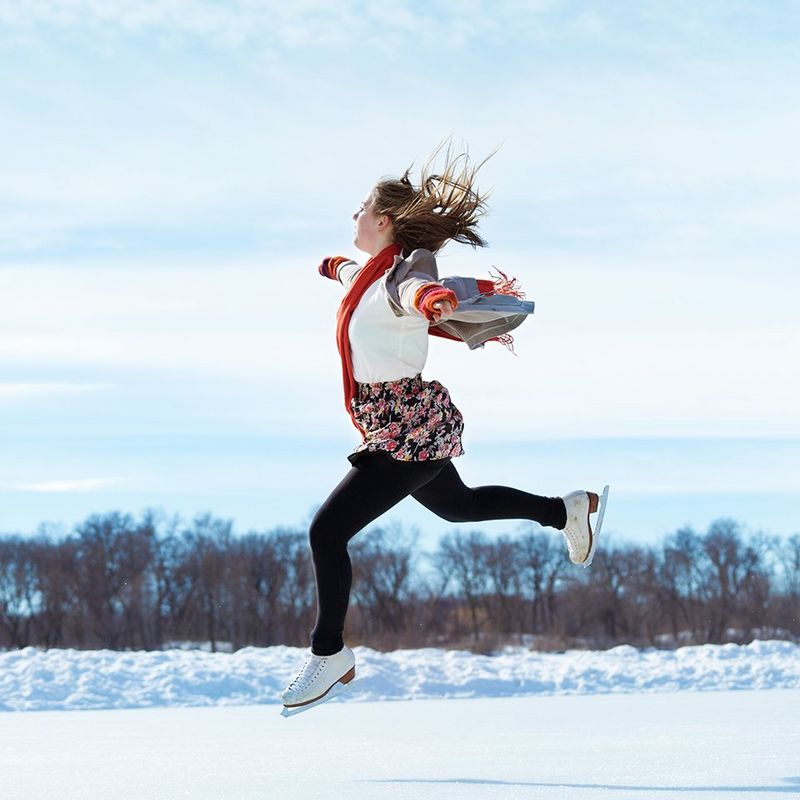Girl iceskating and jumping