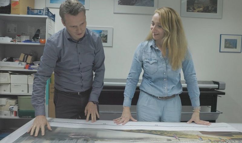 Grassl employees looking at documents printed with ColorWave 3000 series