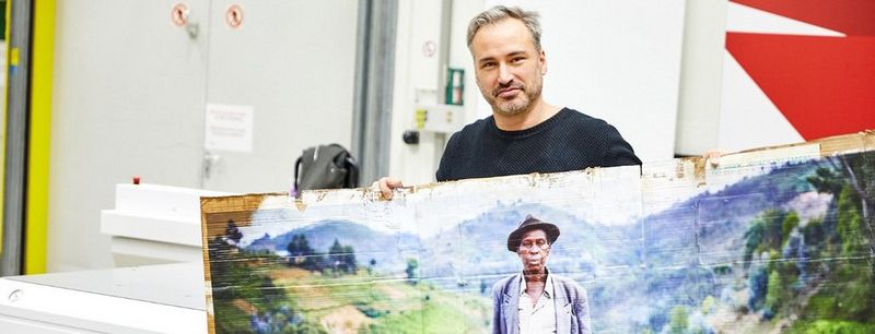 Daniel Sommer with a print from the Arizona flatbed printer