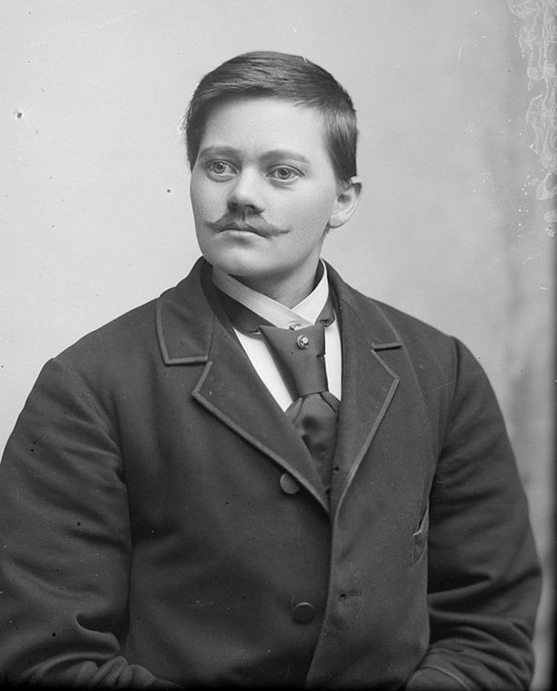 Black and white photo of Marie Høeg wearing in a suit and sporting a moustache.