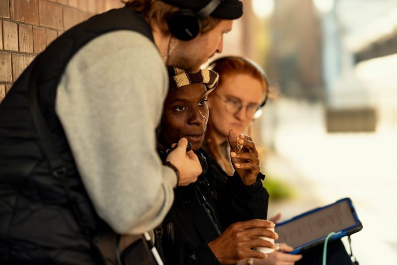 Filmmaker Samona Olanipekuna drinks a small coffee and chats to crew members while taking a break during the filming of i and i.