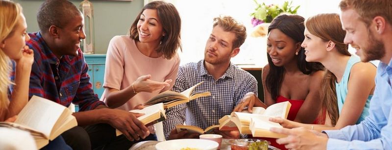 Group of friends taking part in book club