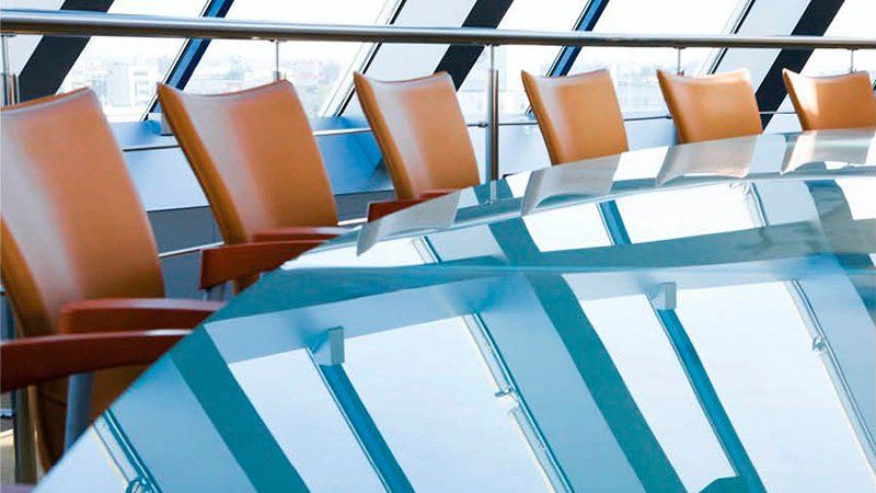 Woman in office processes Accounts Payable paper invoices in front of computer