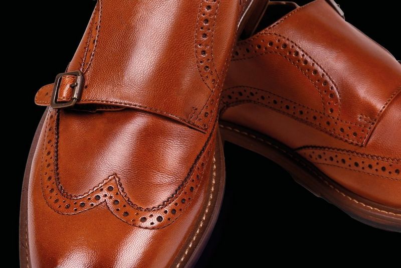 Comparison slider of two image of the same brown leather shoe. The left side shows the shoes in wider view. 