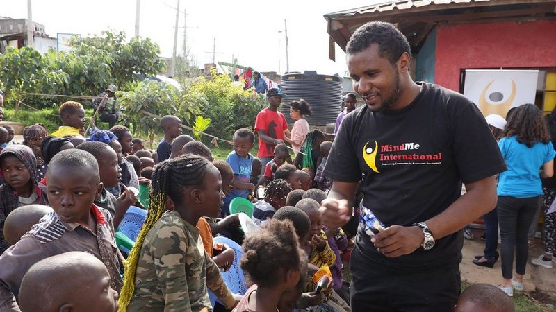 On the right, John Wambugu of MindMe International is surrounded by the children who use the Laibu Mtaani.