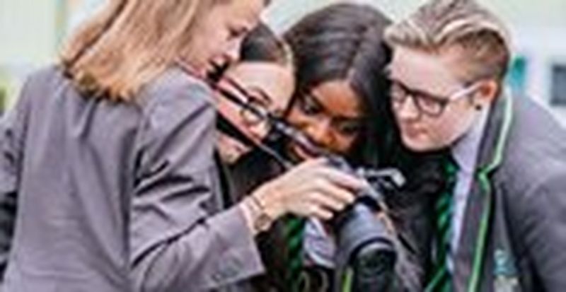 Students looking into a camera