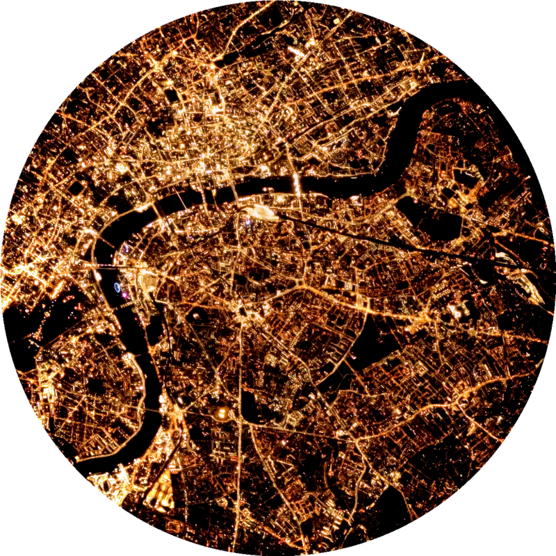 A satellite view of London at night, illuminated by countless lights.