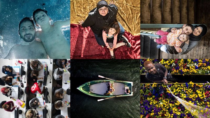 A collage of six images in two rows of three. Top left is a man and a child underwater, looking down at the camera. Top centre: a head scarfed woman with a child on her lap sits on what appears to be a yellow and red striped flag. Top right: A couple and their child stand on a staircase looking up at the camera. Bottom right: a person stands surrounded by flowers, holding a hosepipe and spraying them with water. Bottom centre: The original image of the boat on the sea, as per the page banner. Bottom left: fifteen students, photographed from above as they sit at four white desks, working on computers. In the centre of the image, one person looks up to the camera and smiles.  