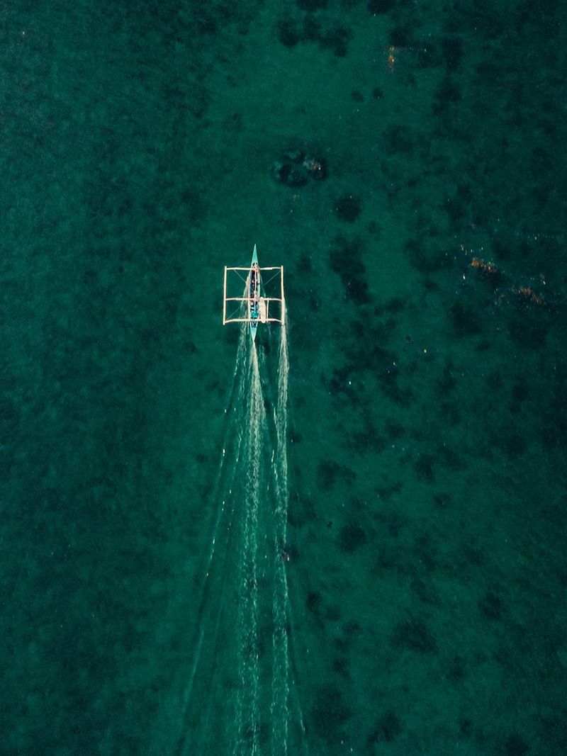 Image d’un petit bateau vue de haut sur l’océan aux philippines