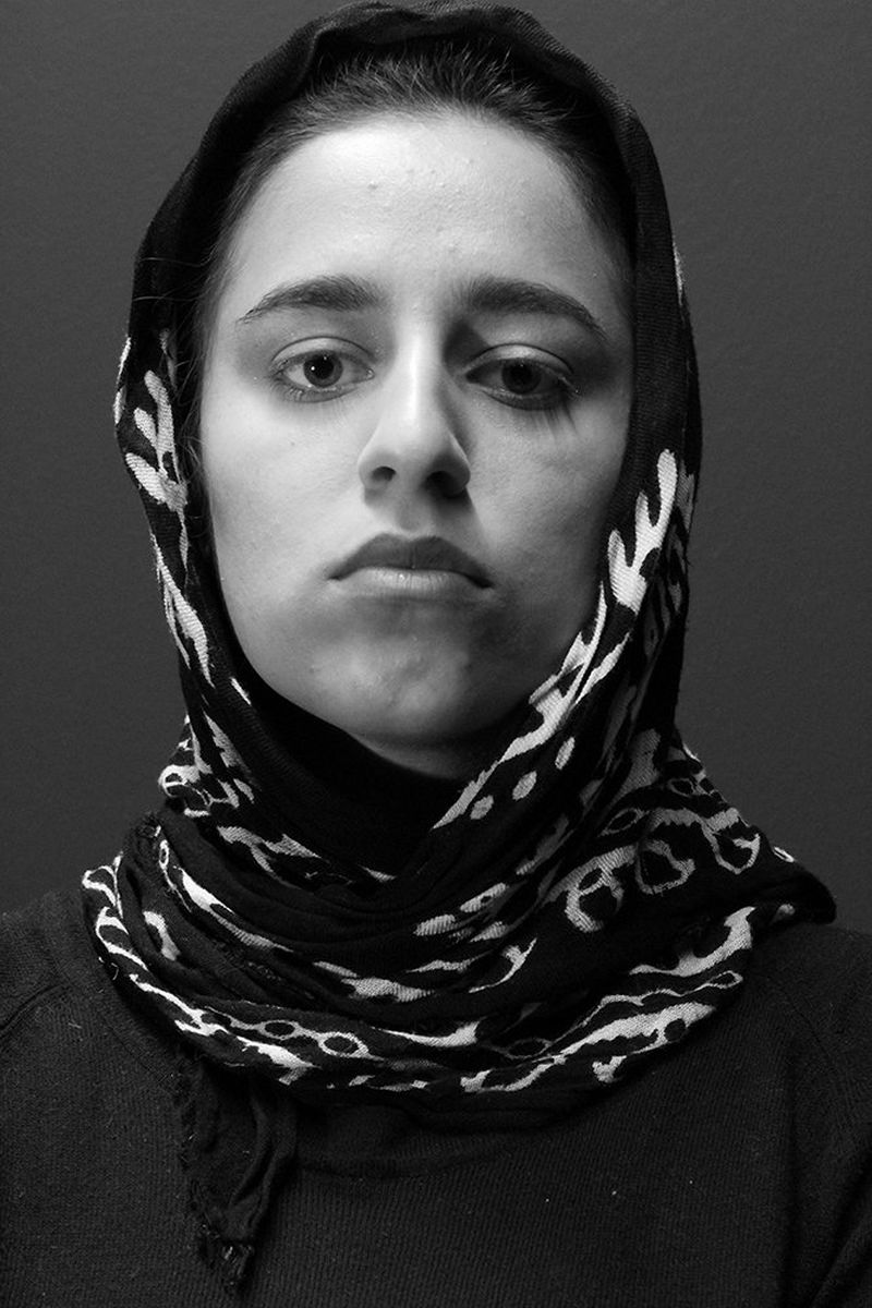 A near identical black and white portrait of Niga Salam, except she is wearing a hijab.