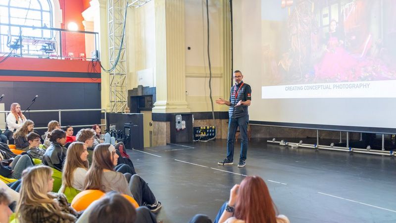 Canon’s Nathan Dua stands in front of an audience of students and in front of the huge projector screen. The words ‘Creating Conceptual Photography’ can be seen behind him.
