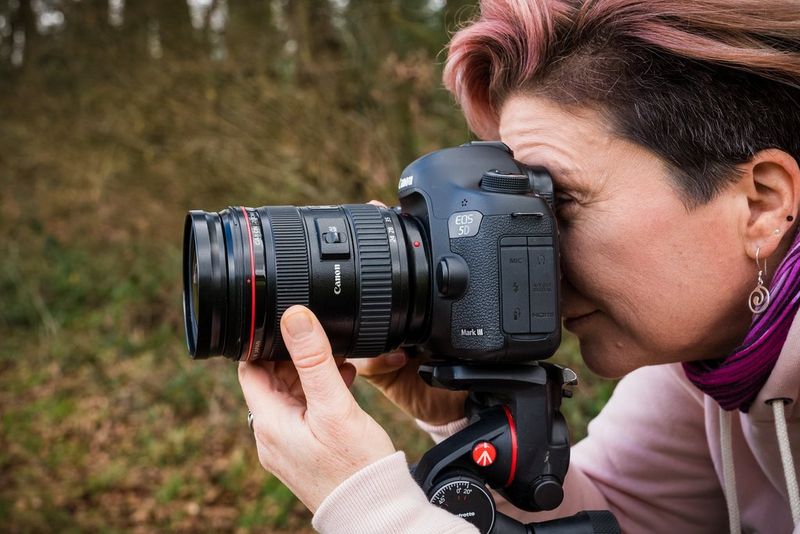 A female photographer holding a camera.