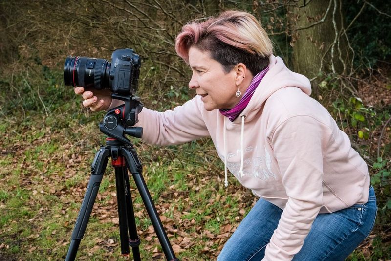 The same photographer looking at the screen of a camera.