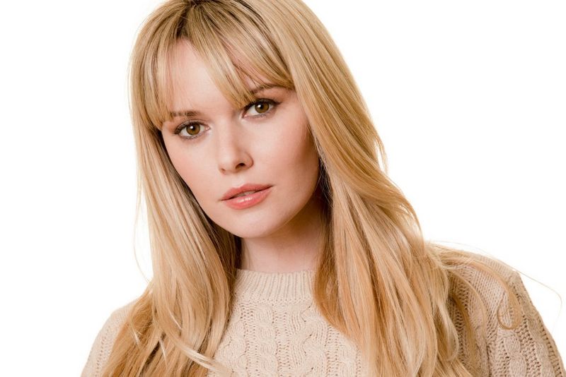 A front-on portrait of a woman with a completely white background, taken with Canon EOS 5D Mark IV. © James Paterson