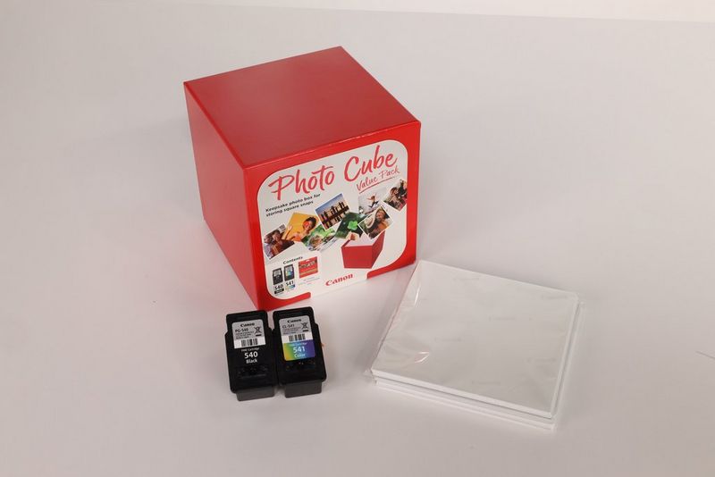 A Canon Photo Cube Value Pack sits next to a pack of paper and ink cartridges. 