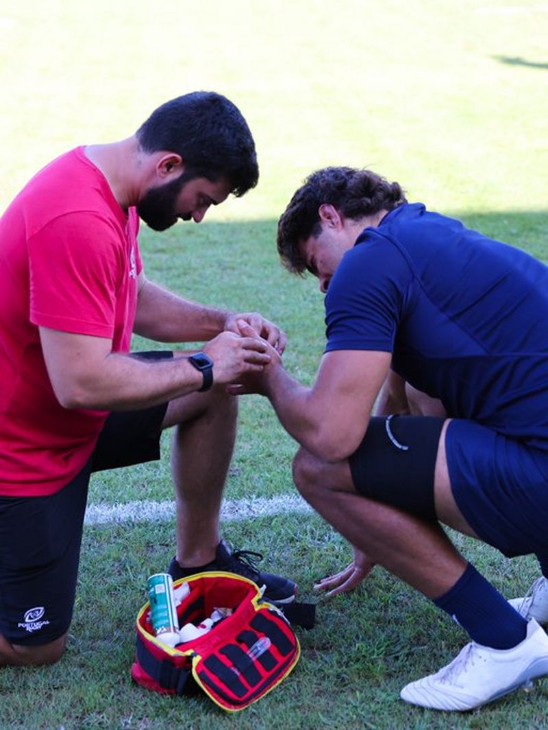 A physio treats a Portugal player's left hand during the training camp