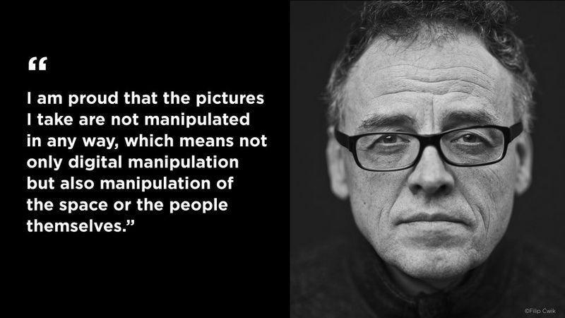 On the right, a black and white portrait of Piotr Malecki, who wears a black polo-neck and black rimmed glasses. On the left, a quote that reads, ““I am proud that the pictures I take are not manipulated in any way, which means not only digital manipulation but also manipulation of the space or the people themselves.”