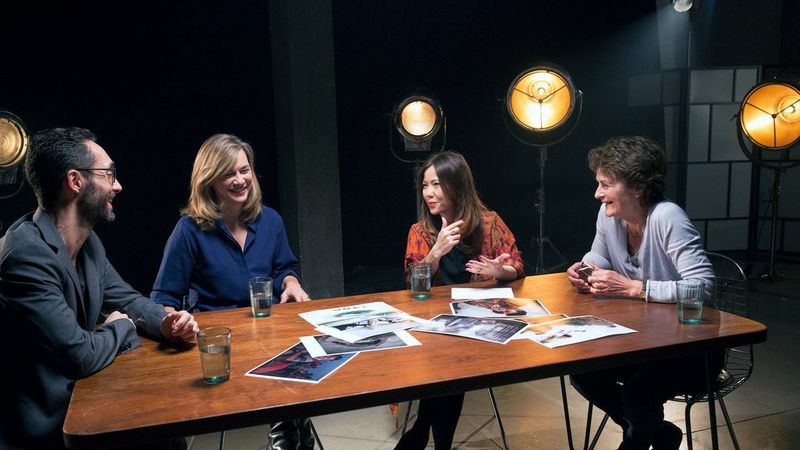 Photographers around a table discussing the industry